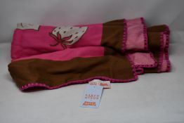 An as new Karen Mabon X Peter Rabbit woven raspberry blanket, part of a limited-edition capsule