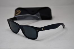 A pair of as new Ray Ban sunglasses.