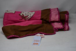 An as new Karen Mabon X Peter Rabbit woven raspberry blanket, part of a limited-edition capsule