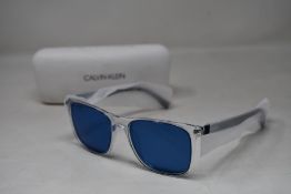 A pair of as new Lacoste sunglasses.