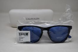 A pair of as new Calvin Klein sunglasses.