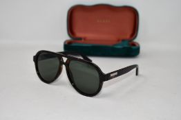 A pair of as new Gucci sunglasses.