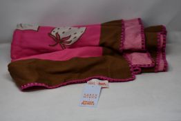 An as new Karen Mabon X Peter Rabbit woven raspberry blanket, part of a limited-edition capsule