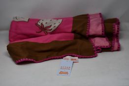 An as new Karen Mabon X Peter Rabbit woven raspberry blanket, part of a limited-edition capsule