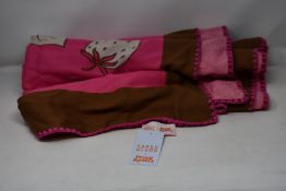 An as new Karen Mabon X Peter Rabbit woven raspberry blanket, part of a limited-edition capsule