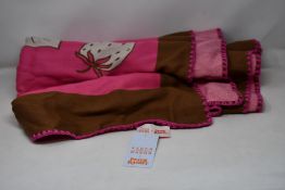 An as new Karen Mabon X Peter Rabbit woven raspberry blanket, part of a limited-edition capsule