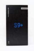 A boxed as new Samsung Galaxy S9+ SM-G965F/DS 64GB in Coral Blue (Box sealed. Two pin plug).