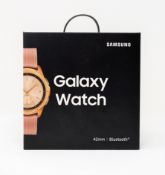 A boxed as new Samsung Galaxy Watch (SM-R810) 42mm in Rose Gold (Box sealed. UK plug).