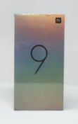 A boxed as new Xiaomi Mi 9 Dual LTE 128GB 6GB Smartphone in Ocean Blue (Box sealed. 2-pin plug