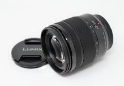 An as new Panasonic H-FS12060 Lumix G Vario 12-60mm F3.5-5.6 Lens (Plain box).