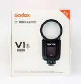 A boxed as new Godox V1s TTL Round Head Camera Flash for Sony (Two pin plug included).
