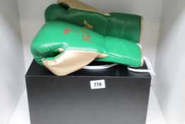 A pair of as new Fly superlace x green/gold 12oz boxing gloves.