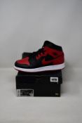 A pair of youths as new Nike Air Jordan 1 Mid (UK 6).
