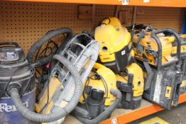 Three pre-owned DeWalt wet/dry vacuum/hoovers, three DeWalt tool cases, a DeWalt area light/charger,