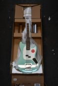 A boxed as new Squier Classic Vibe 60's Mustang Bass Guitar in Surf Green.