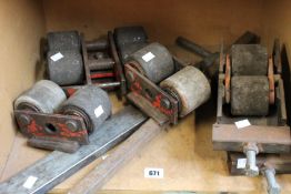 Five pre-owned machine skates and two bars.