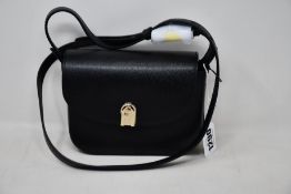 An as new Furla 1927 crossbody bag in black.