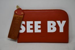 An as new Chloe See By Chloe tablet pouch in red sand.