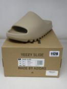 A pair of as new Adidas Yeezy Slide with authentication tag (UK 11).