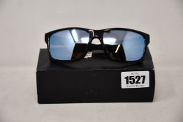 A pair of as new Oakley Mainlink sunglasses.