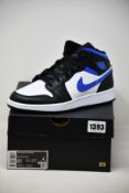 A pair of youths as new Nike Air Jordan 1 Mid (UK 6).