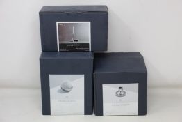 A boxed as new Georg Jensen Henning Koppel Collection stainless steel mirror and glass, a boxed as