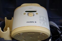 A Medela Symphony hospital grade breast pump (Unit and case only).