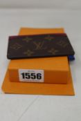 An as new Louis Vuitton leather card holder.