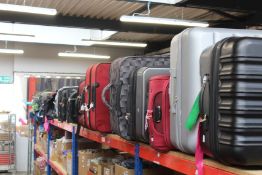 A quantity of empty suitcases/holdalls (Approximately 35 items).
