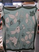 An as new Karen Mabon X Peter Rabbit woven green blanket, part of a limited-edition capsule