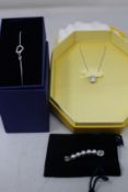 An as new Swarovski simple bracelet (5524421), chain with pendant (5599177) and a necklace