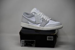 A pair of as new Nike Air Jordan 1 Low PRM (UK 7).