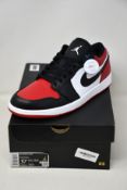 A pair of as new Nike Air Jordan 1 Low with authentication tag (UK 9.5).