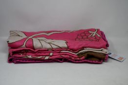 An as new Karen Mabon X Peter Rabbit woven raspberry blanket, part of a limited-edition capsule