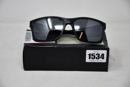 A pair of as new Oakley Mainlink sunglasses.