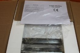 A boxed as new Crispy Machine 117N (UK adaptor required).