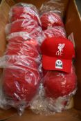 A quantity of official Liverpool F.C. caps in red (Approximately 45).