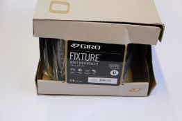 A Giro Foray (L, matt white/silver) and a Giro Fixture (U, matt warm black) cycling helmets, both as