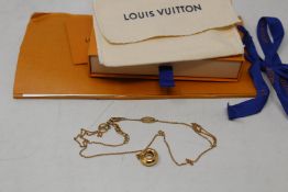 A Louis Vuitton necklace.