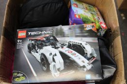 A box of miscellaneous items to include household items, toys, books and Lego.