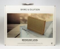 A boxed as new Bang & Olufsen Beosound Level Portable Wireless Home Speaker in Gold (Box opened).
