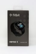 A boxed as new fitbit versa 3 smartwatch in black aluminium with black infinity band.