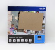 A boxed as new Brother VC-500WCR Design & Craft Label Printer (Box sealed, damage to box).