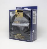 A boxed as new pair of Sony MDR-7506 sound monitor headphones in black.