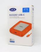A pre-owned boxed LaCie 4TB rugged USB-C storage drive in orange/aluminium.