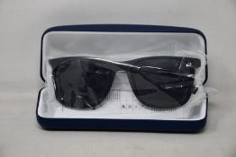 A pair of as new Lacoste sunglasses.