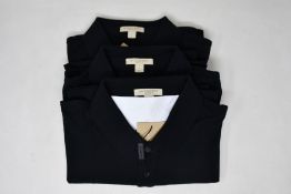 Two as new Burberry polo shirts in black (XL).