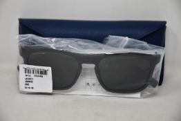 A pair of as new Lacoste sunglasses.