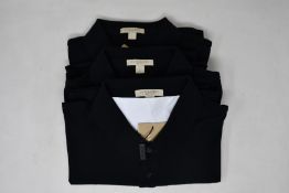Two as new Burberry polo shirts in black (XXL).