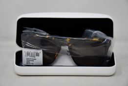 A pair of as new Calvin Klein sunglasses.